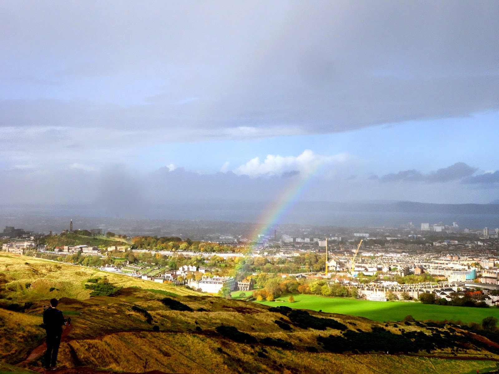 View of Edinburgh Holyrood Palace & rainbow from Arthur's Seat