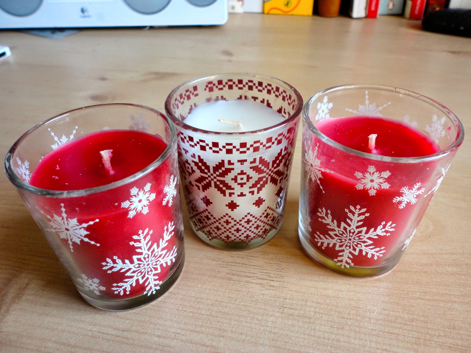 Red and white Christmas scented candles in glass holders