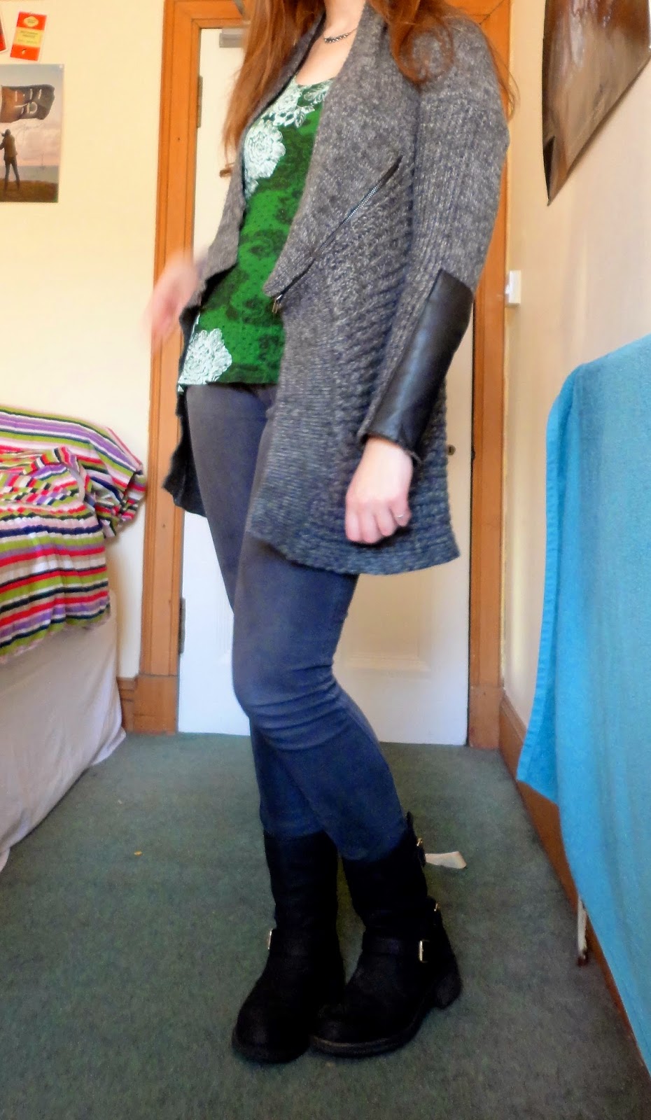 Winter outfit of grey cardigan, green top, jeans and boots
