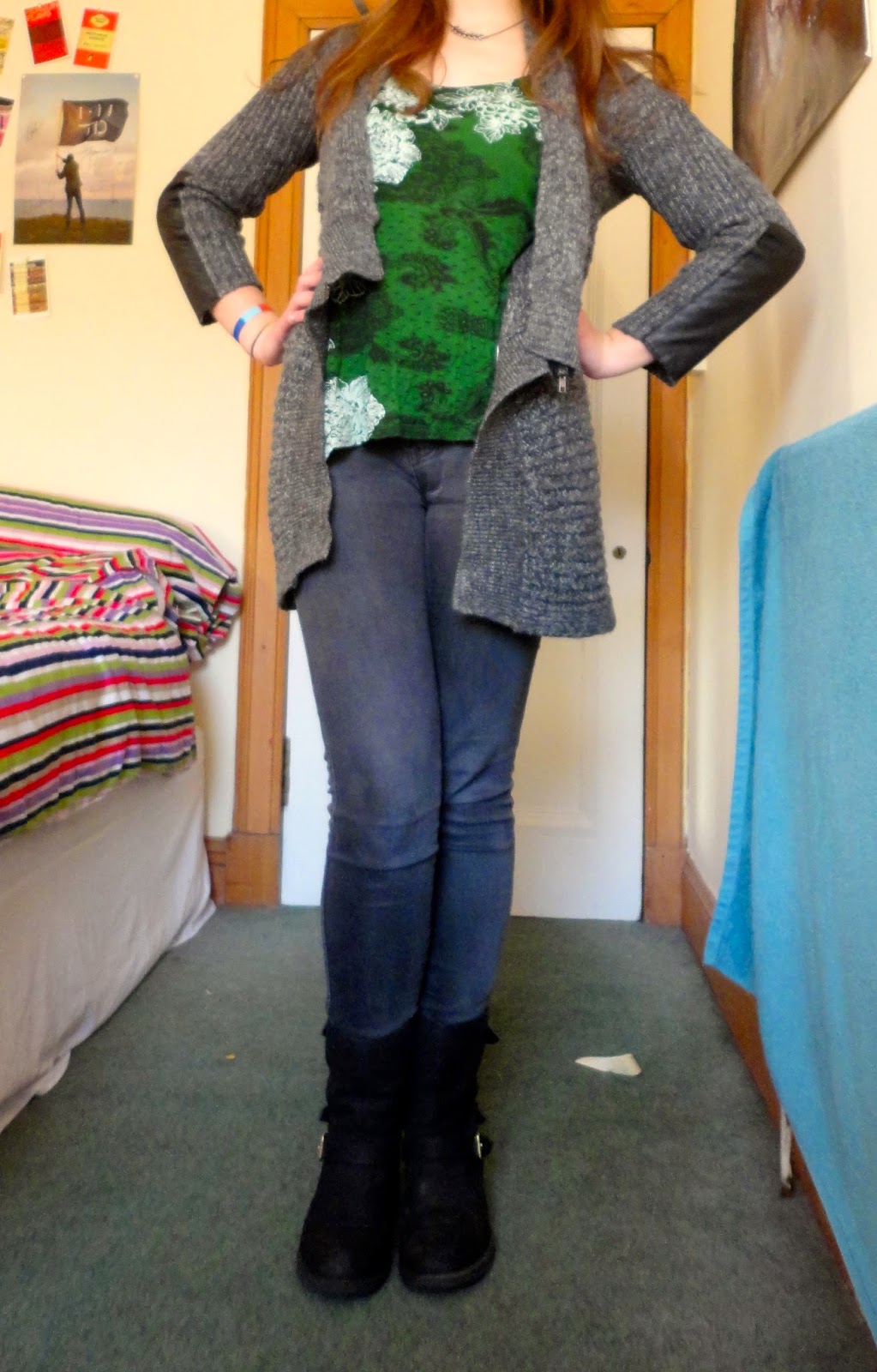Winter outfit of grey cardigan, green top, jeans and boots