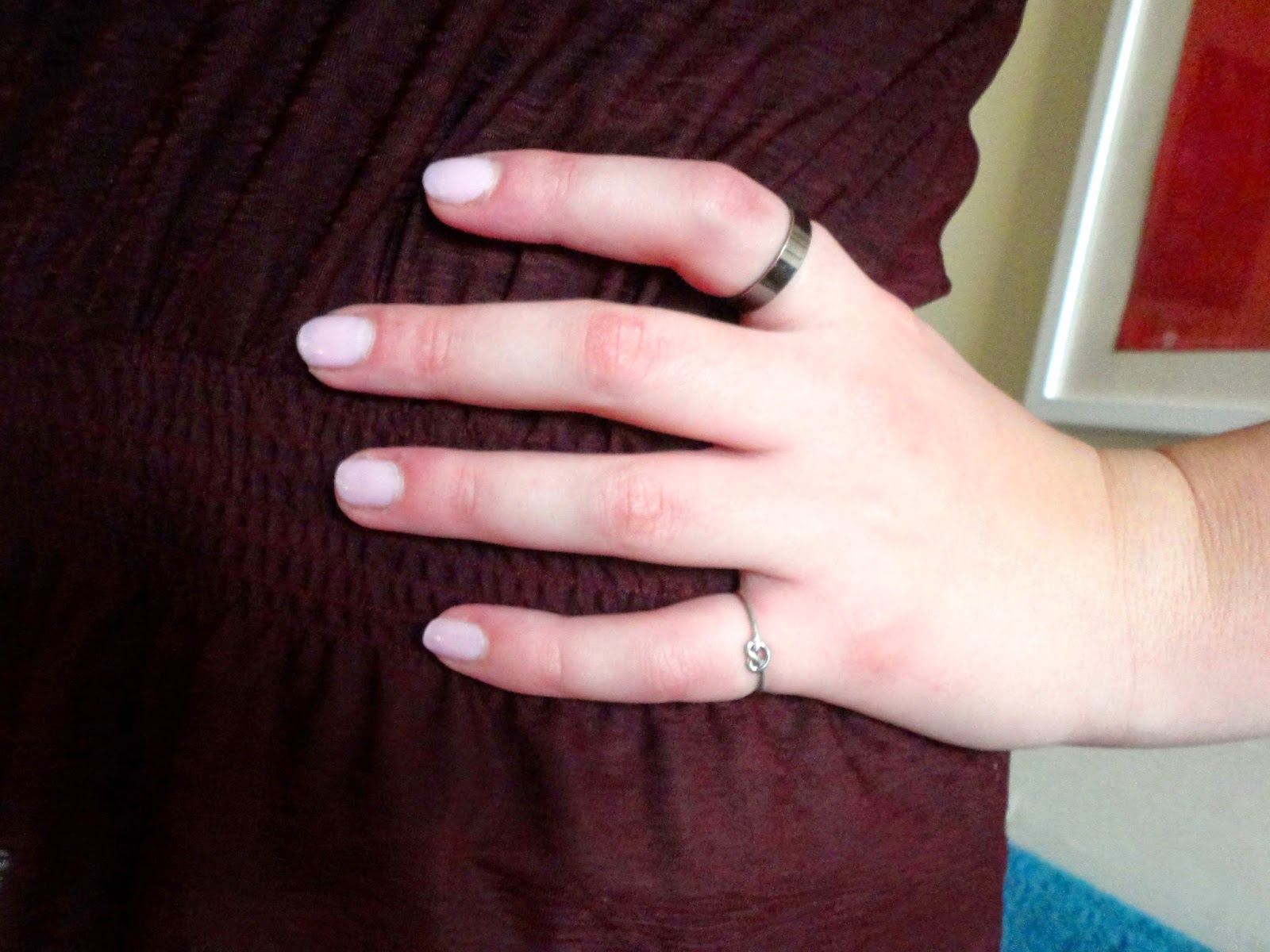 black and silver rings, pink nail polish with deep red peplum top