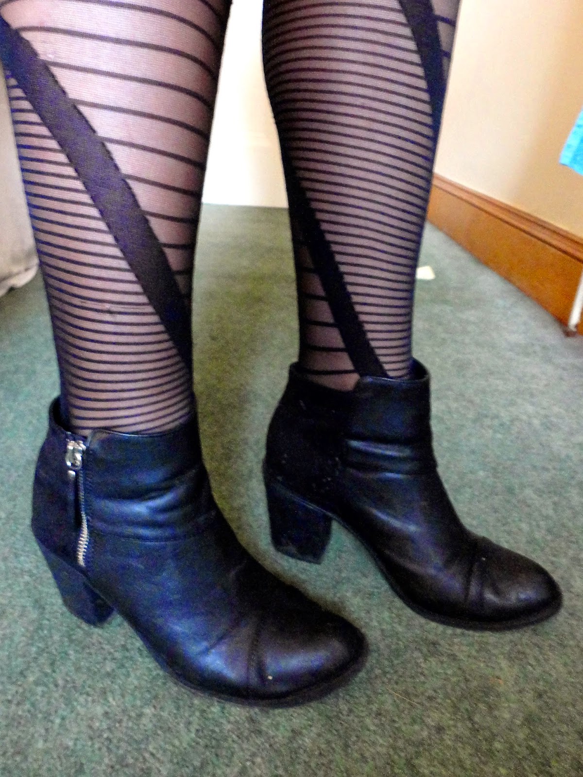 black high heel ankle boots with irregular striped tights