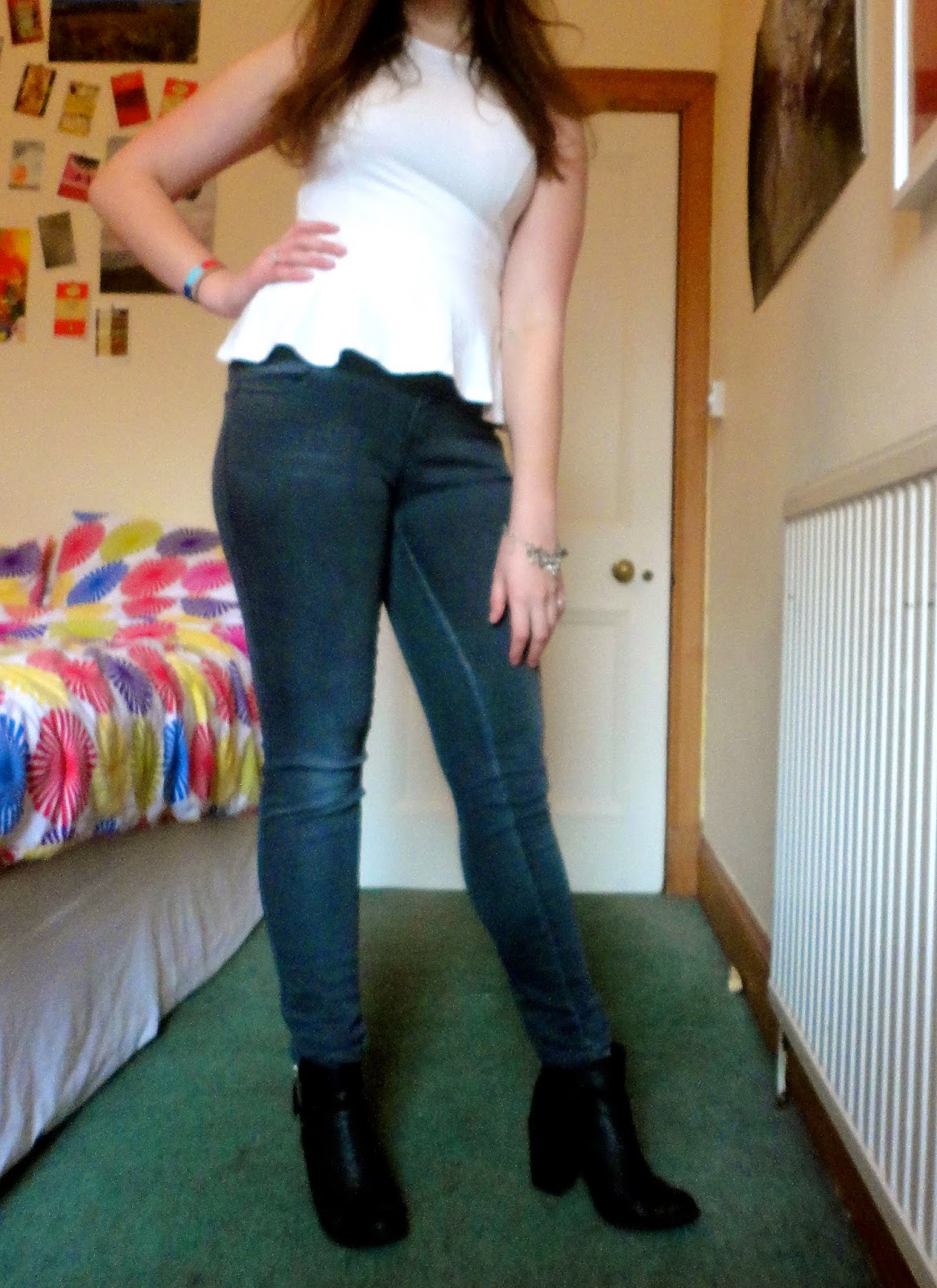 Outfit of white peplum top, grey skinny jeans & black heeled ankle boots