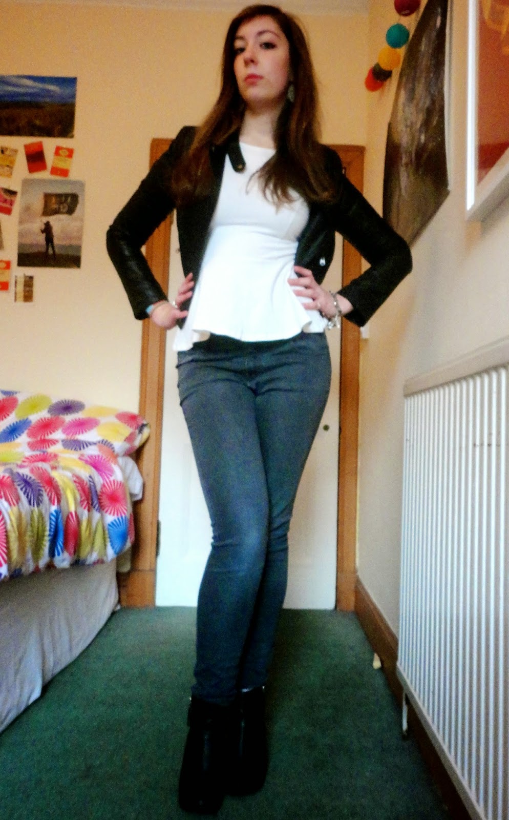 Outfit of black leather jacket, white peplum top, grey skinny jeans & black heeled ankle boots