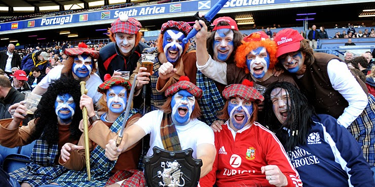 Scotland rugby fans with saltire face paint and tartan kilts and bonnets