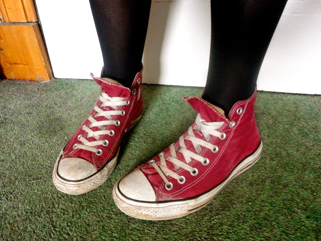 Rocker chick outfit details | red high top converse sneakers with black tights