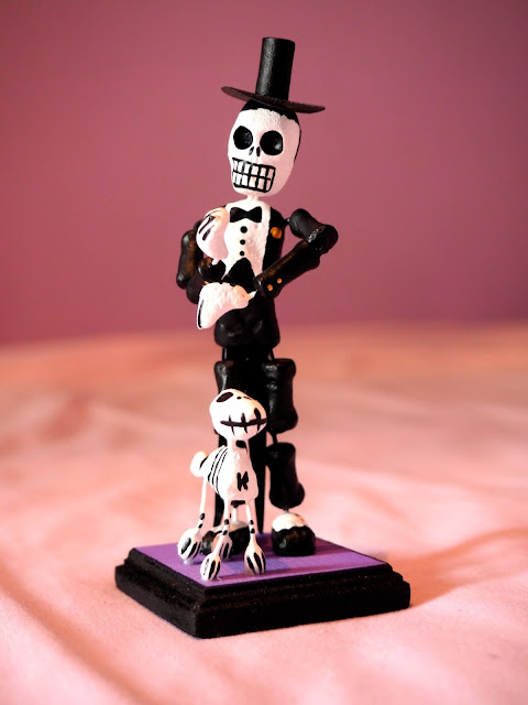 Model of a skeleton in suit & top hat, with dog, from Mexico