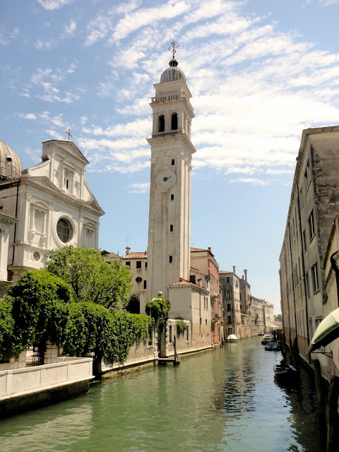 Church and belltower by a canal in Venice, Italy