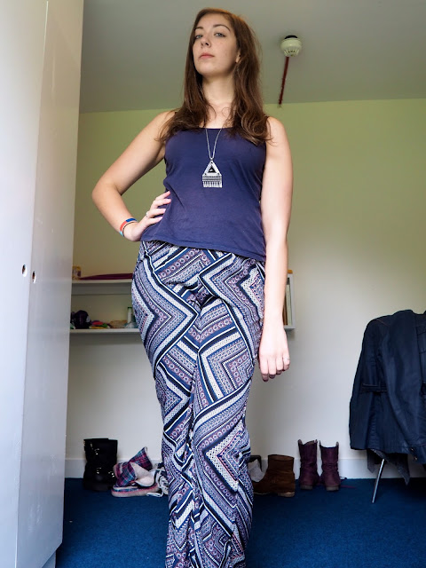Printed Patterns | outfit of dark blue vest top, blue, purple and pink patterned trousers, and striped espadrilles