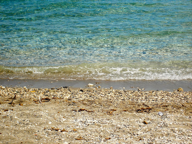 Pebbles and ocean waves on a beach on Kefalonia, Greece