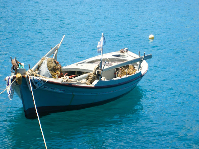 Tiny wooden fishing boat in the ocean on Kefalonia, Greece