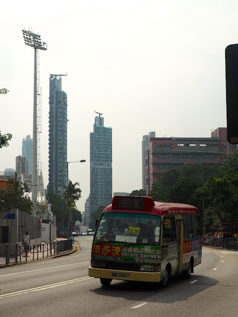 Skyscrapers and a minibus in Mong Kok, Kowloon, Hong Kong