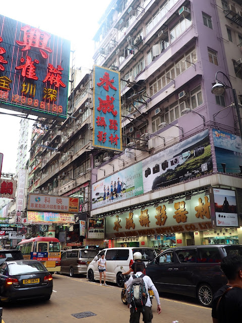 Signs, skyscrapers & traffic in the streets of Mong Kok, Kowloon, Hong Kong