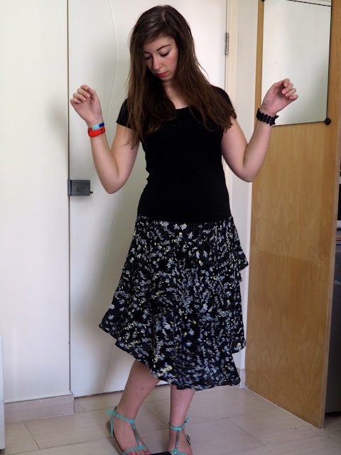 Crazy Daisy | outfit of black top, floaty black daisy pattern skirt & green strappy sandals