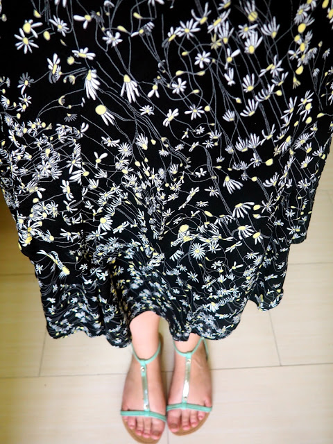 Crazy Daisy | outfit details of floaty black daisy pattern skirt & green strappy sandals