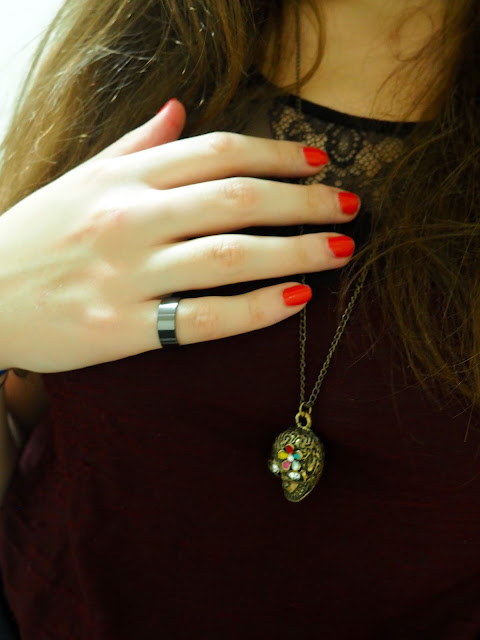 Something Wicked | outfit jewellery details of gold sugar skull pendant necklace, plain black metal ring, and bright red nail polish
