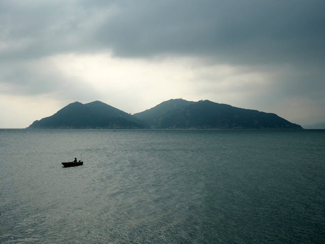 Shek Kwu Chau Island, and boat at sea, taken from near the Reclining Rock on Cheung Chau Island, Hong Kong