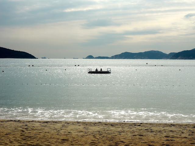 Silhouettes of girls on a raft in the ocean off Repulse Bay Beach, Hong Kong