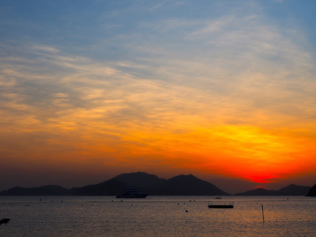 Pink, blue, orange and red skies of the sunset on Repulse Bay Beach, Hong Kong