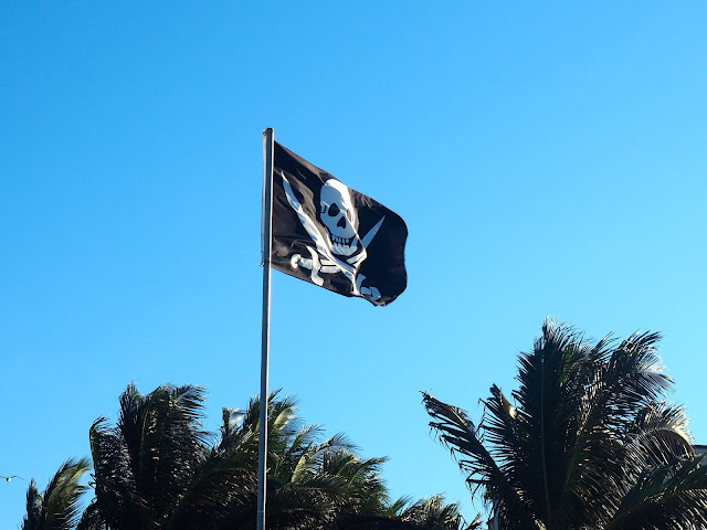 Jolly Roger pirate flag flying on Playa del Carmen beach, Mexico
