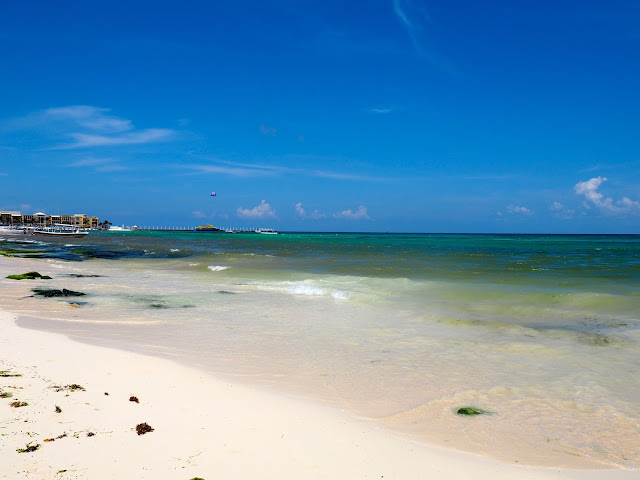 Sand and blue ocean at the beach in Playa del Carmen, Mexico