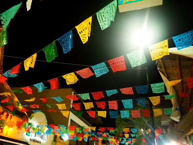 Colourful flags above the streets of Playa del Carmen, Mexico, at night