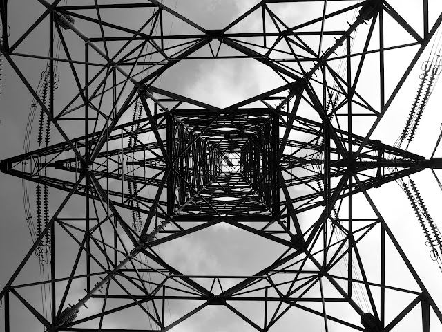 An electricity pylon from below, in black and white, on the Lion Rock trail, Hong Kong