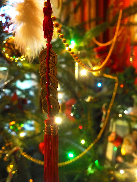 Lucky Chinese coins on a red tassel - Christmas tree decoration brought back from Hong Kong