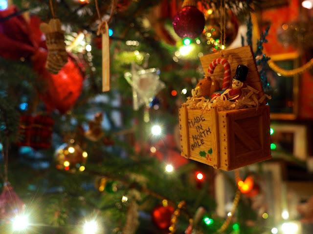 Toy box ornament amongst decorations and lights on the Christmas tree