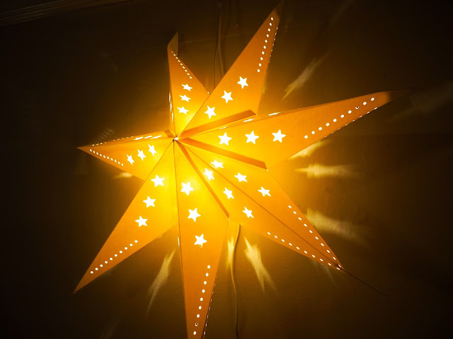 Big light up star decorating the living room for Christmas
