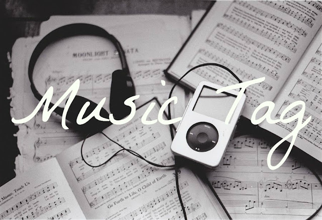 Music Tag text on black and white background of iPod, headphones and sheet music