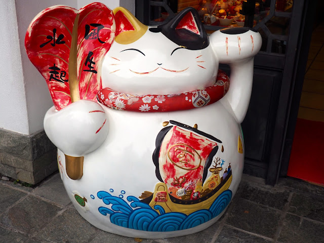 Funny fat cat statue with Chinese designs in Ngong Ping village, Lantau Island, Hong Kong