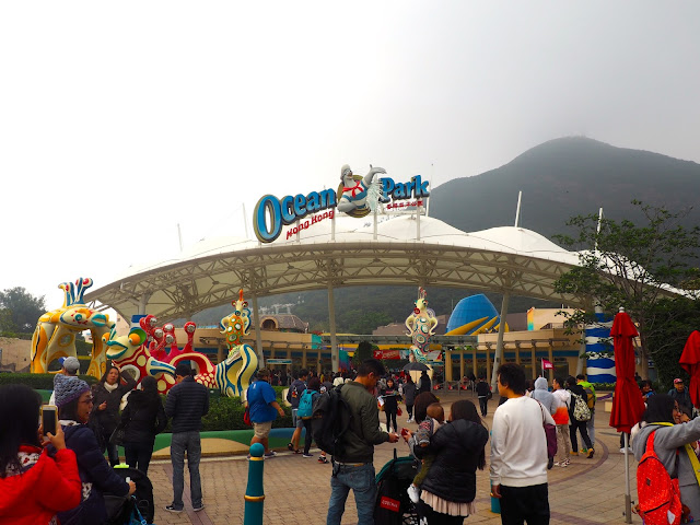 Ocean Park entrance with sign and sea animal statues, Hong Kong