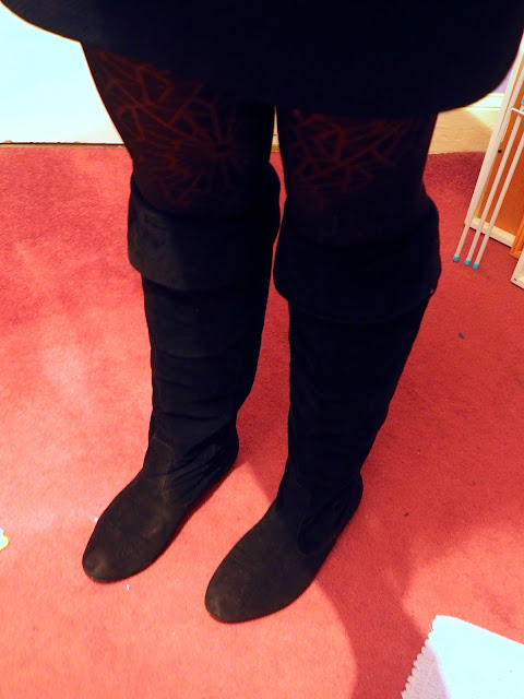 Knee high black suede boots with top folded down