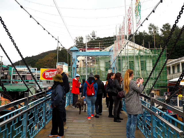 Bridge full of people, crossing the water in Tai O fishing village, Lantau Island, Hong Kong