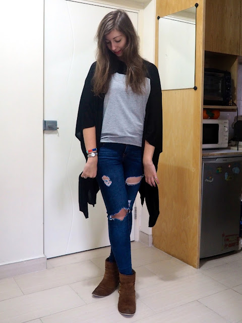 Rough Around the Edges | casual outfit of grey t-shirt, black cape cardigan, ripped jeans and brown ankle boots