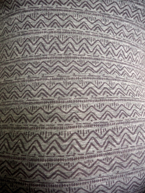 Hiking | outfit close up of geometric purple design on light grey top