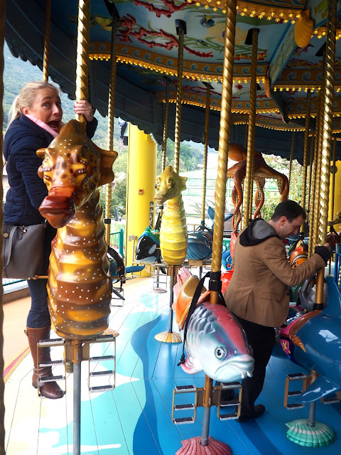 Trying to choose animals on the Sea Life Carousel in Ocean Park, Hong Kong