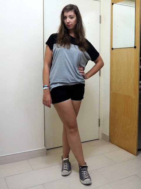 Thundercloud | casual outfit of grey and black loose t-shirt, black denim shorts and blue high top Converse