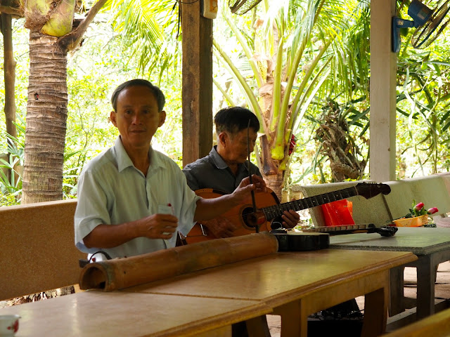 Local musicians playing traditional instruments in the Mekong Delta, Vietnam