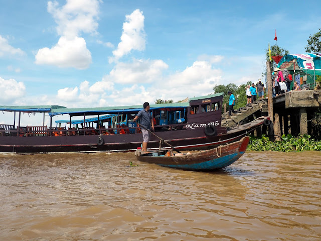 Large and small traditional wooden boats in the Mekong Delta, Vietnam