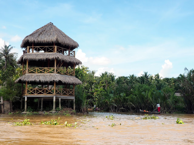 Wooden structures and fishing boats in the canals of the Mekong Delta, Vietnam