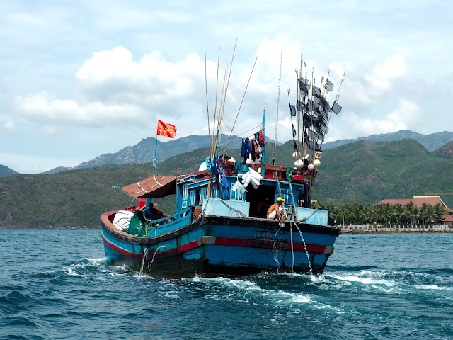Traditional Vietnamese fishing boat sailing near the harbour at Nha Trang, Vietnam