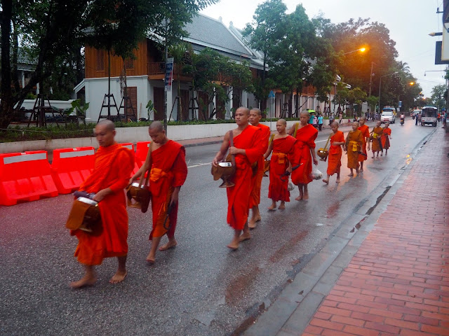 Monks collecting food donations early in the morning in Luang Prabang, Laos