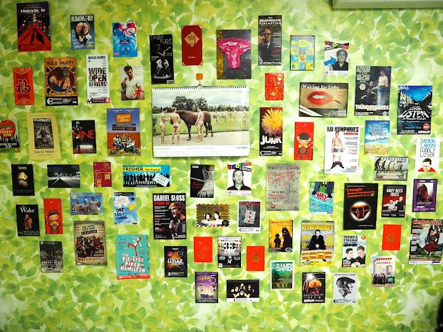 Wall decoration display, with calendar, Edinburgh Fringe flyers and Chinese red packets - inside studio apartment in Busan, South Korea