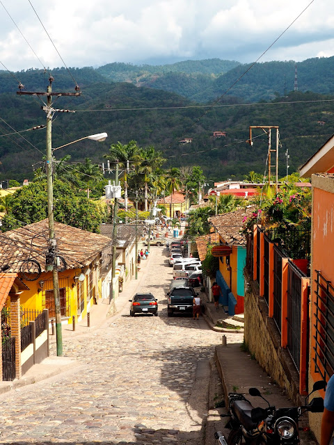 Looking down a cobbled street towards the town square of Copan, Honduras