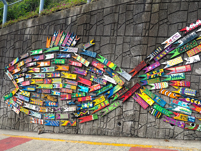 Large colourful fish made from small fish signs - art installation in Gamcheon Village, Busan, South Korea