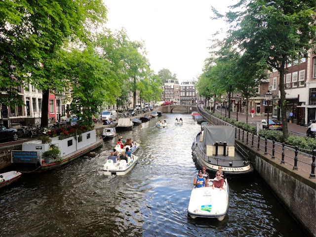 Boats and pedalos in the canals of Amsterdam | Netherlands, Europe