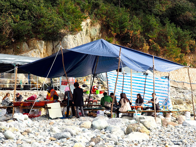 Seafood tent on pebble beach in Taejongdae Park, Busan, South Korea