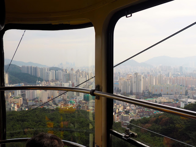 Views of Busan from inside Geumgang cable car, up Geumjeongsan Mountain, Busan, South Korea